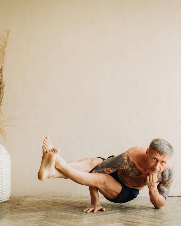 Man performing a controlled strength exercise in a calm environment.